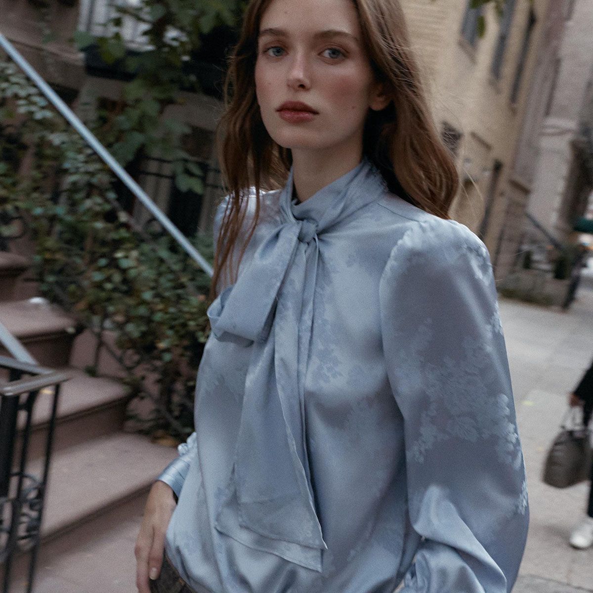 Woman in icy blue blouse