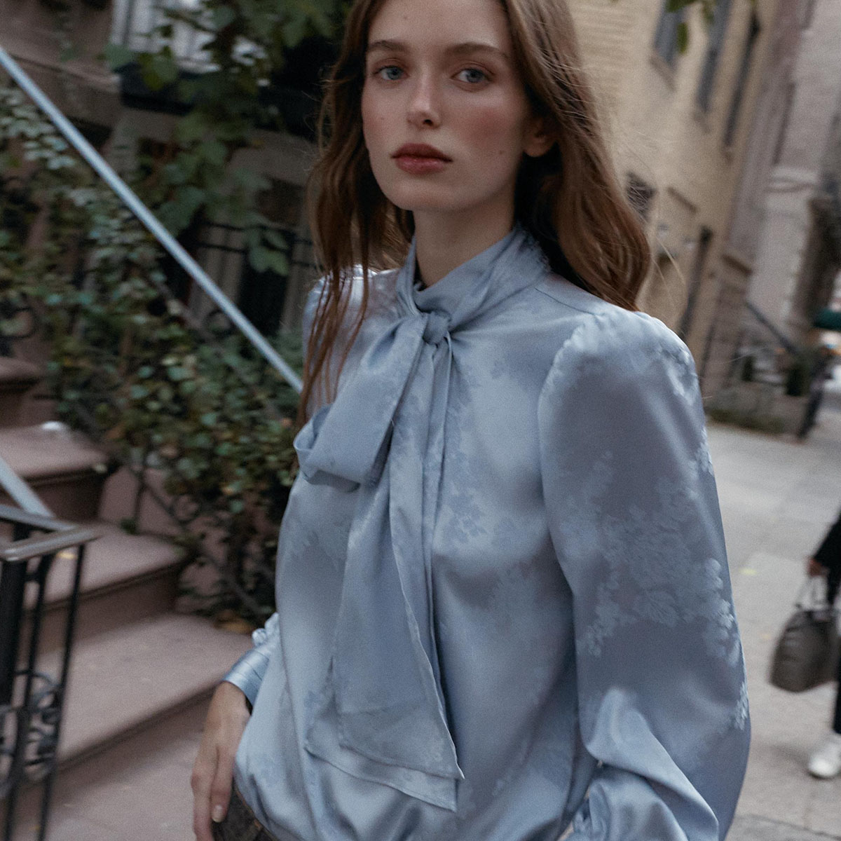 Woman in icy blue blouse