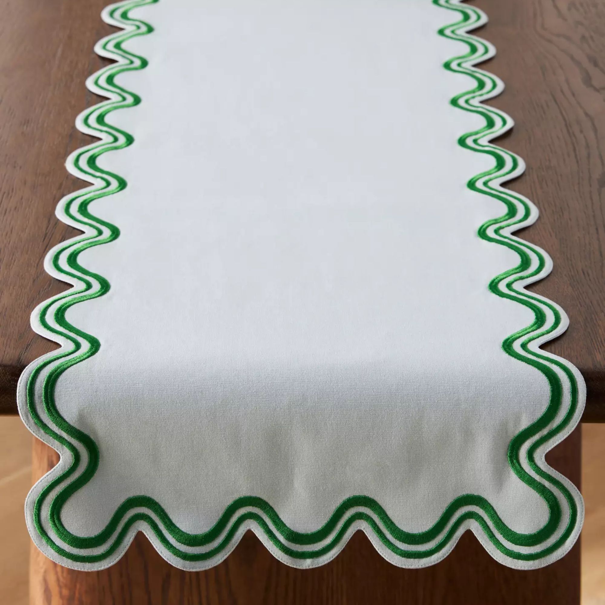 White table runner with green scallop trim