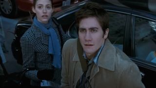 Emmy Rossum and Jake Gyllenhaal look up in bewilderment in The Day After Tomorrow.