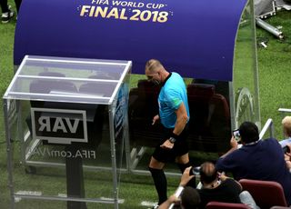 Nestor Pitana checks the monitors during the 2018 World Cup final between France and Croatia