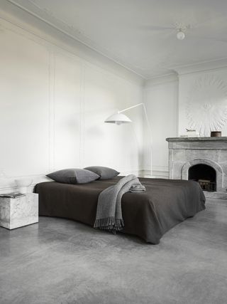 minimalist bedroom with grey flooring and white walls
