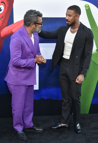 Jordan Peele and Michael B. Jordan shaking hands at the premiere of Nope.