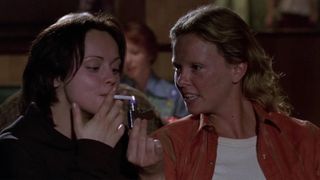 Christina Ricci and Charlize Theron lighting a cigarette in Monster