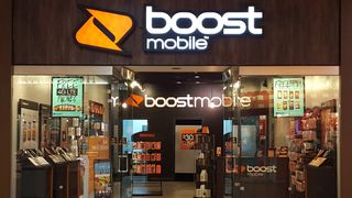 A Boost Mobile store with deals signs in the window