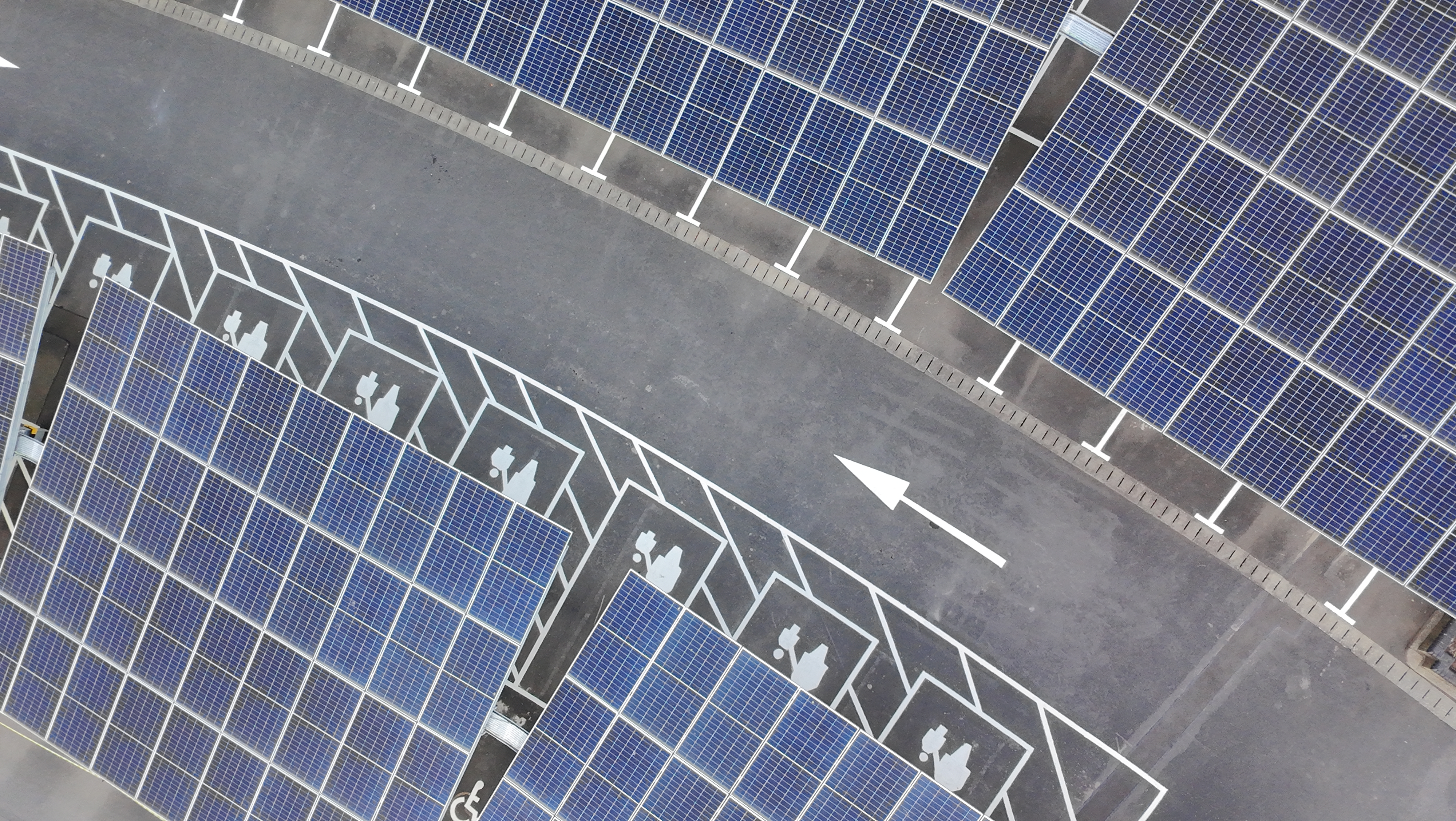 Close up view of a road in a car park with solar panels taken with DJI Neo.