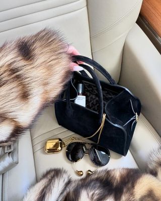 Rosie Huntington-Whitley with Maison Crivelli perfume in handbag