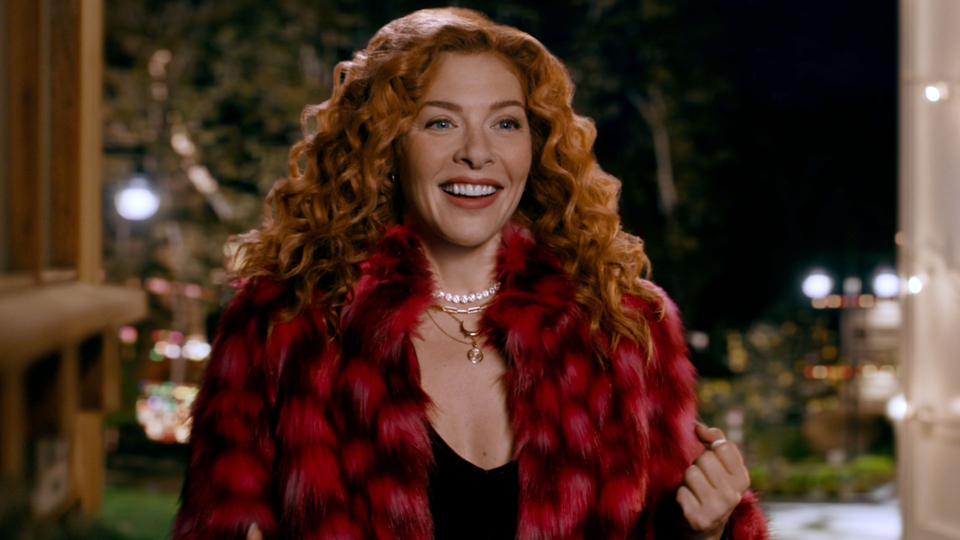 Rachelle Lefevre smiles in a red and black fur coat
