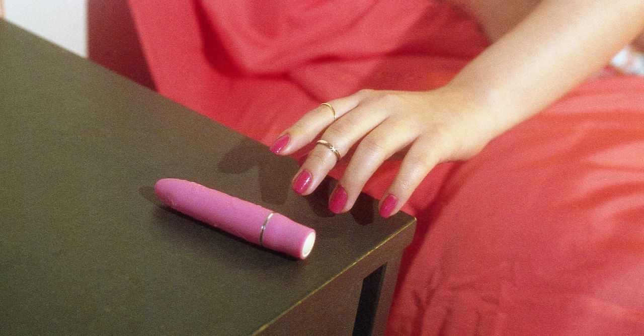 Young Woman Reaching For Vibrator