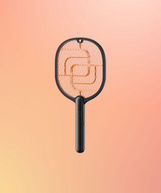 Electric fly swatter on an orange ombré background