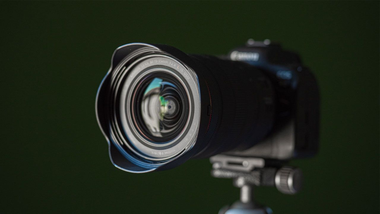 Our review image shows the Canon RF 15-35MM F2.8L IS USM lens mounted on a camera and tripod.