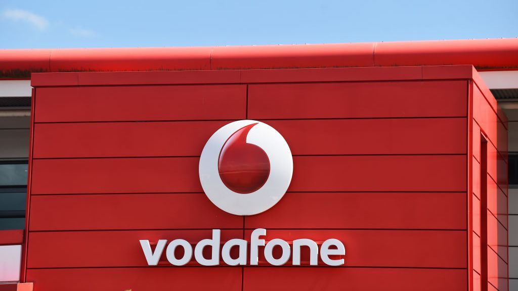 A wide angle shot of the vodafone logo on the side of a building