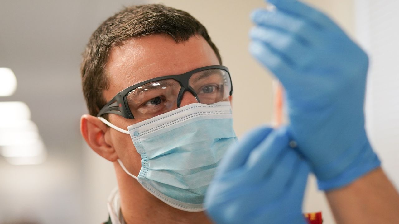 A paramedic draws up the AstraZeneca/Oxford University