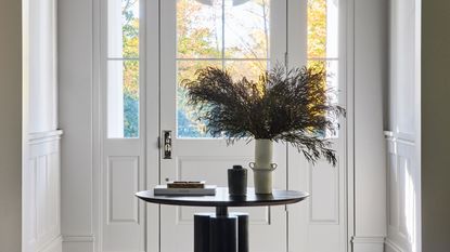 an entryway with a round table in the middle