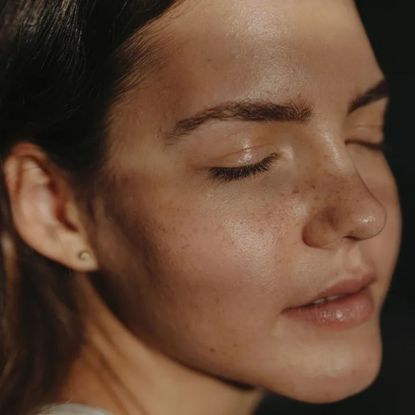 portrait of young woman with natural skin, no make-up and skin texture showing