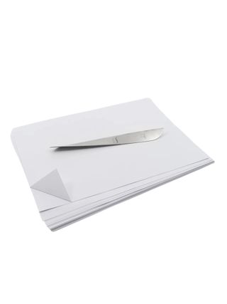 Chrome paper knife with a minimalist look sits atop some paper.