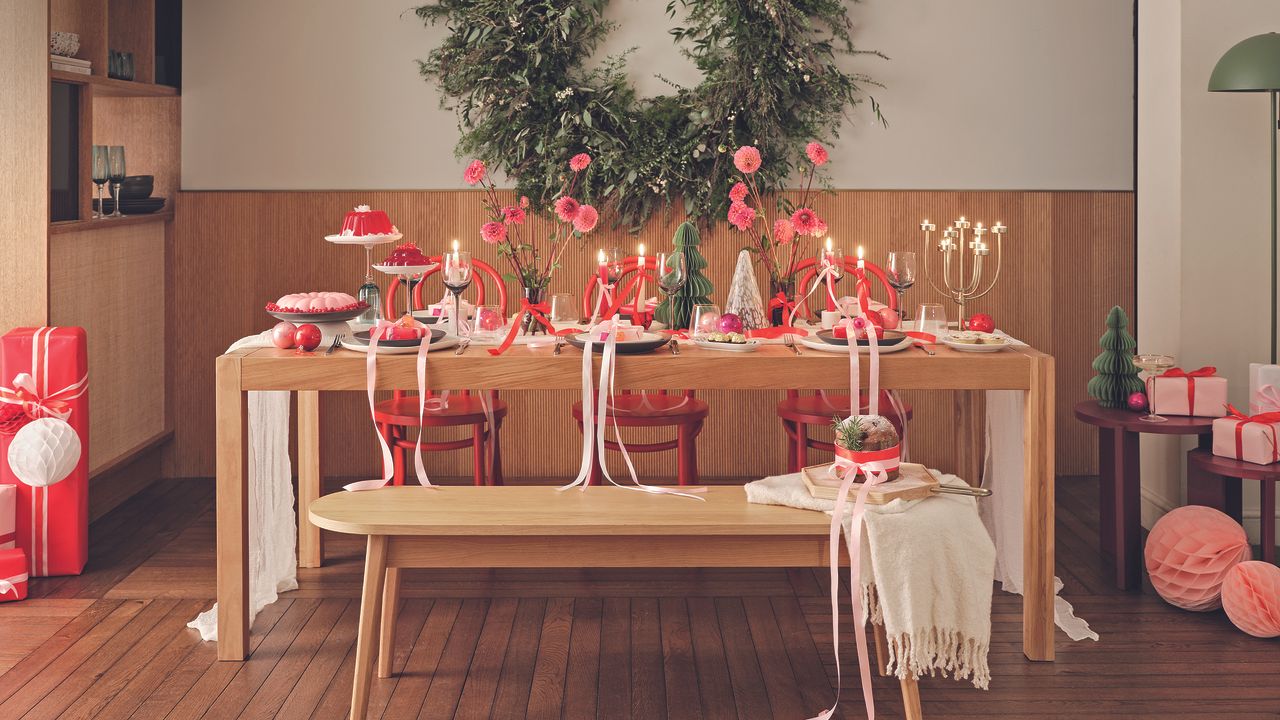 Habitat table and bench with pink and red festive tablescape.