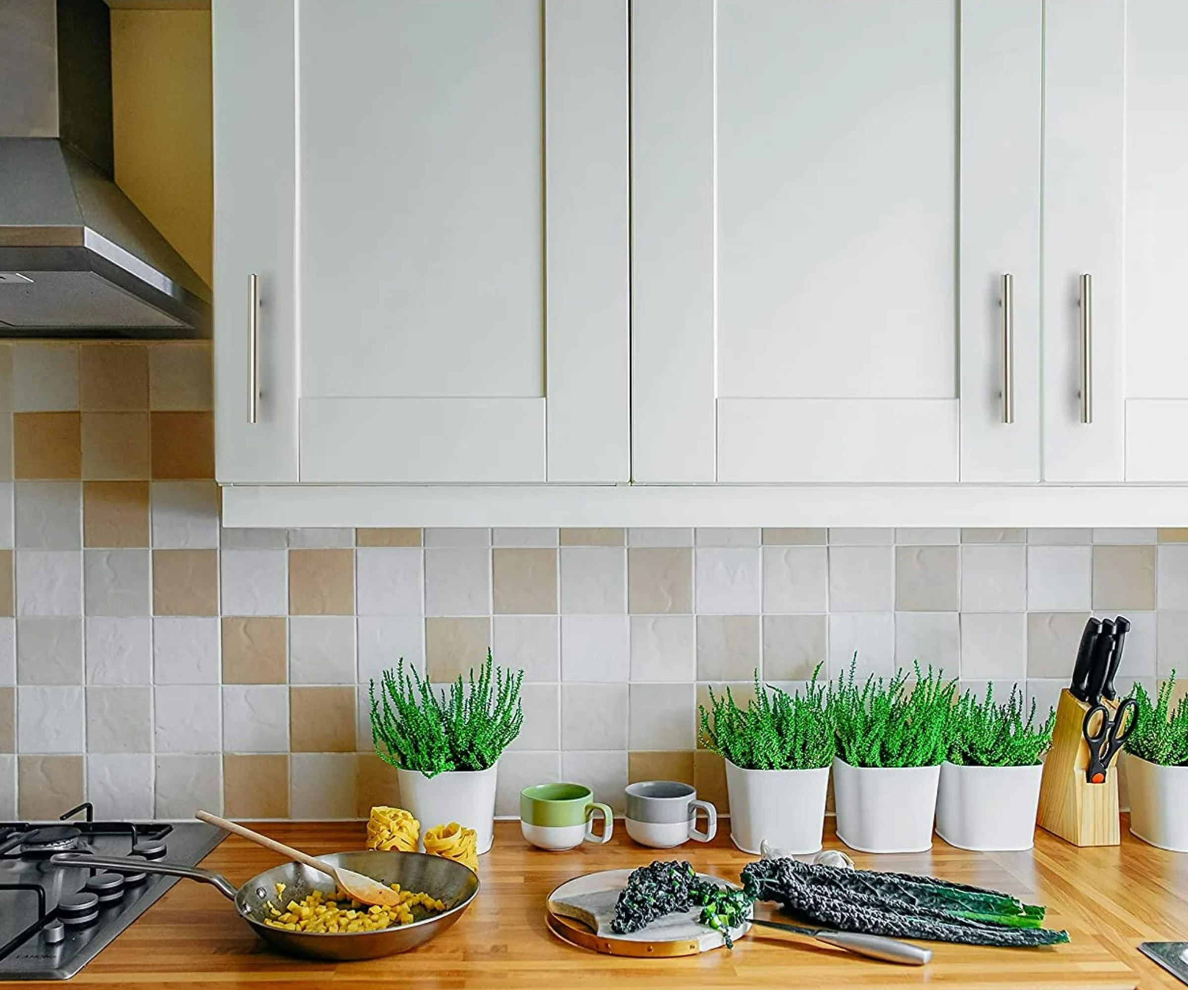 A white walmart kitchen with chrome hardware and wooden countertops