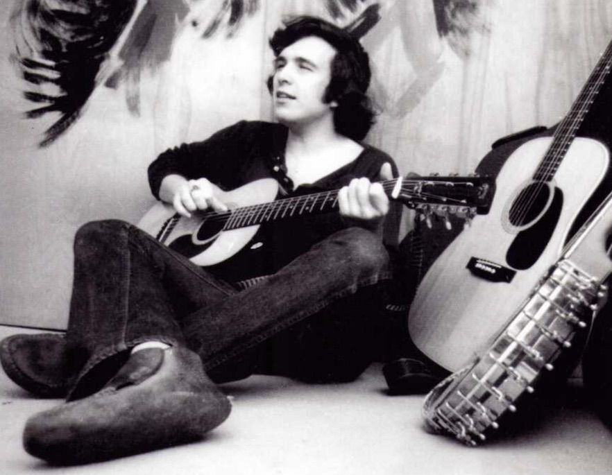 Don McLean, surrounded by other instruments, plays his 1969 Martin 00-21 guitar