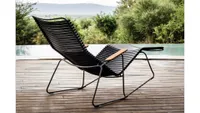 A reclining outdoor chair designed with black wooden slats