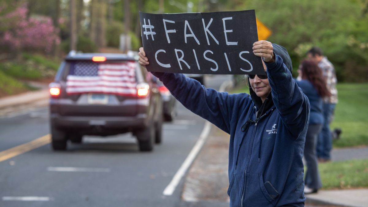 Protestors holding up signs. Demonstrators hold a &quot;Rolling Car Rally&quot; in front of Democratic Governor Ned Lamont&#039;s residence while protesting the state&#039;s stay-at-home order to combat the coronavirus (COVID-19) pandemic on May 04, 2020 in Hartford, Connecticut. 