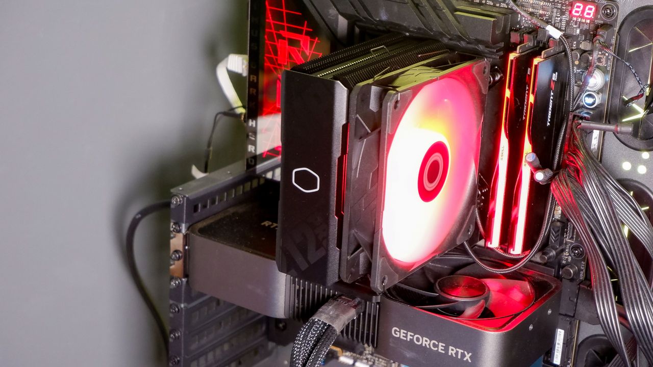 A Cooler Master Hyper 212 Pro air cooler with its packaging and installed on a gaming PC.