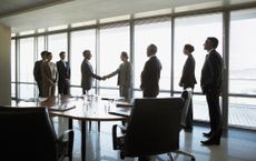 Business people shaking hands in conference room