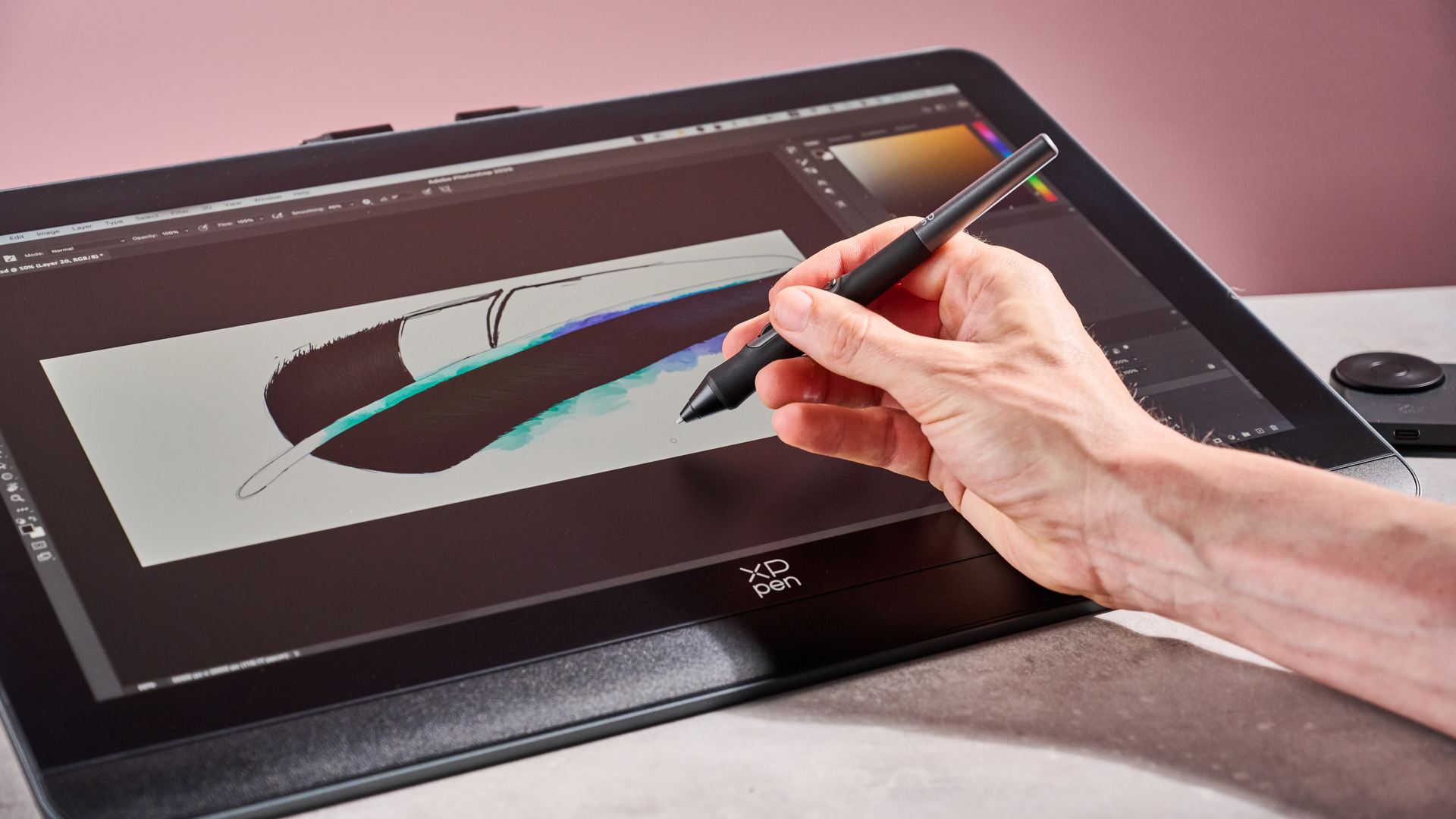 A man drawing a magpie feather on the screen of the XPPen Artist Pro 19 Gen 2.