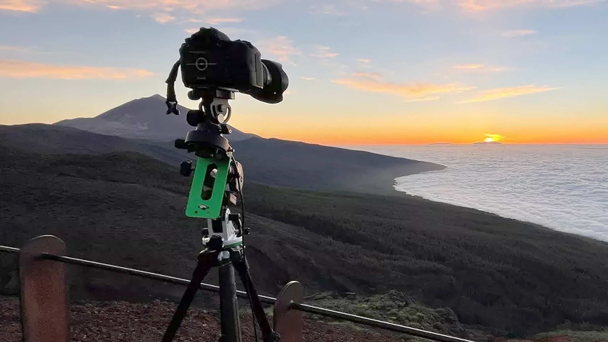 Sky-watcher star adventurer mini being used atop a mountain overlooking a sunrise