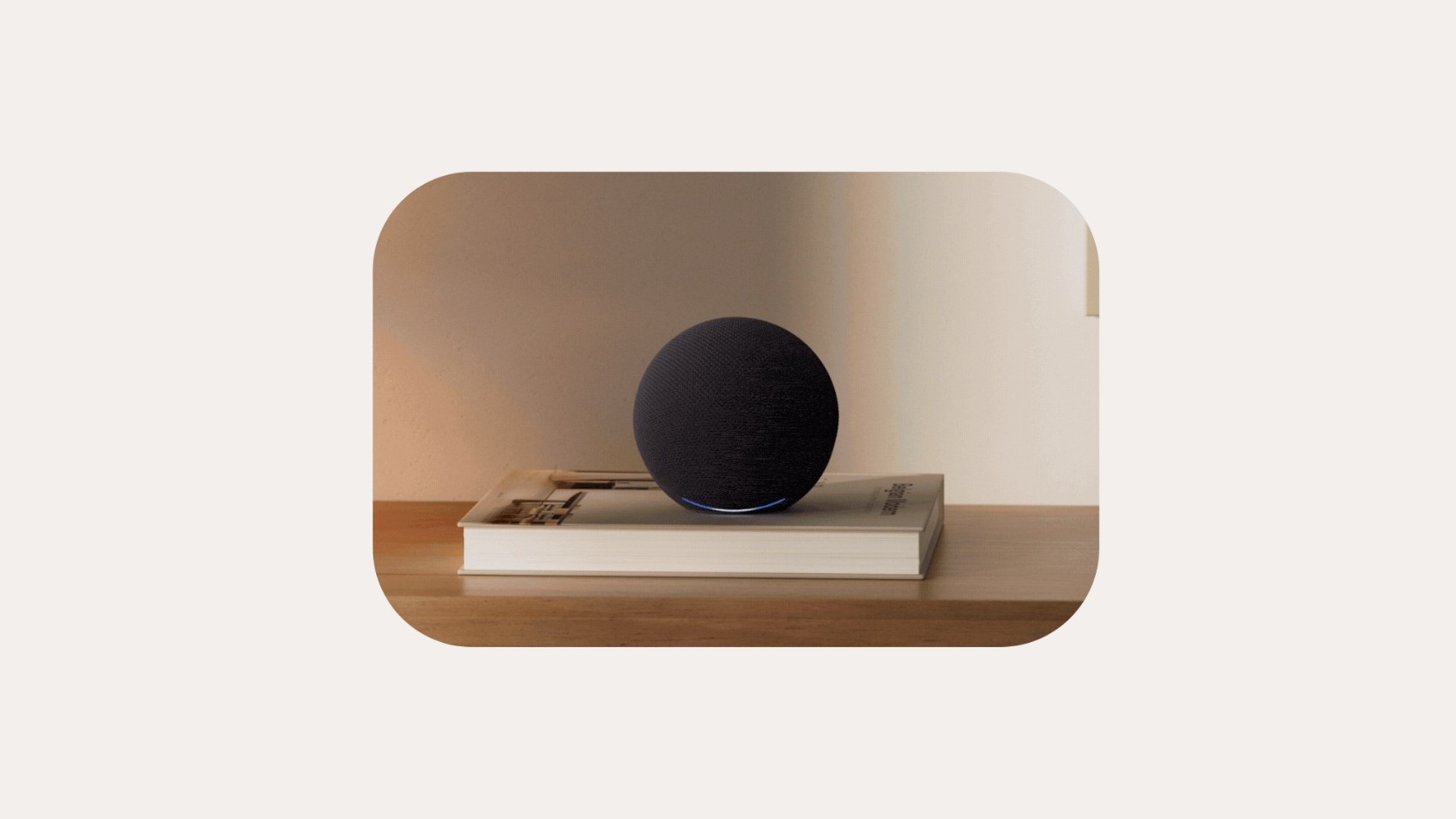 The Amazon Echo Dot 2026 sitting on a book on a table.