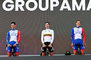 On the left, Jacopo Guarnieri (Groupama-FDJ) wears a a wristband of the light blue, pink and white colours of the transgender flag at the pre-race presentation of the Giro d'Italia 