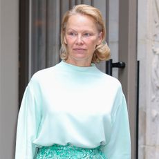 Pamela Anderson paired a monochromatic skirt set with Strathberry's Mosaic Bag.