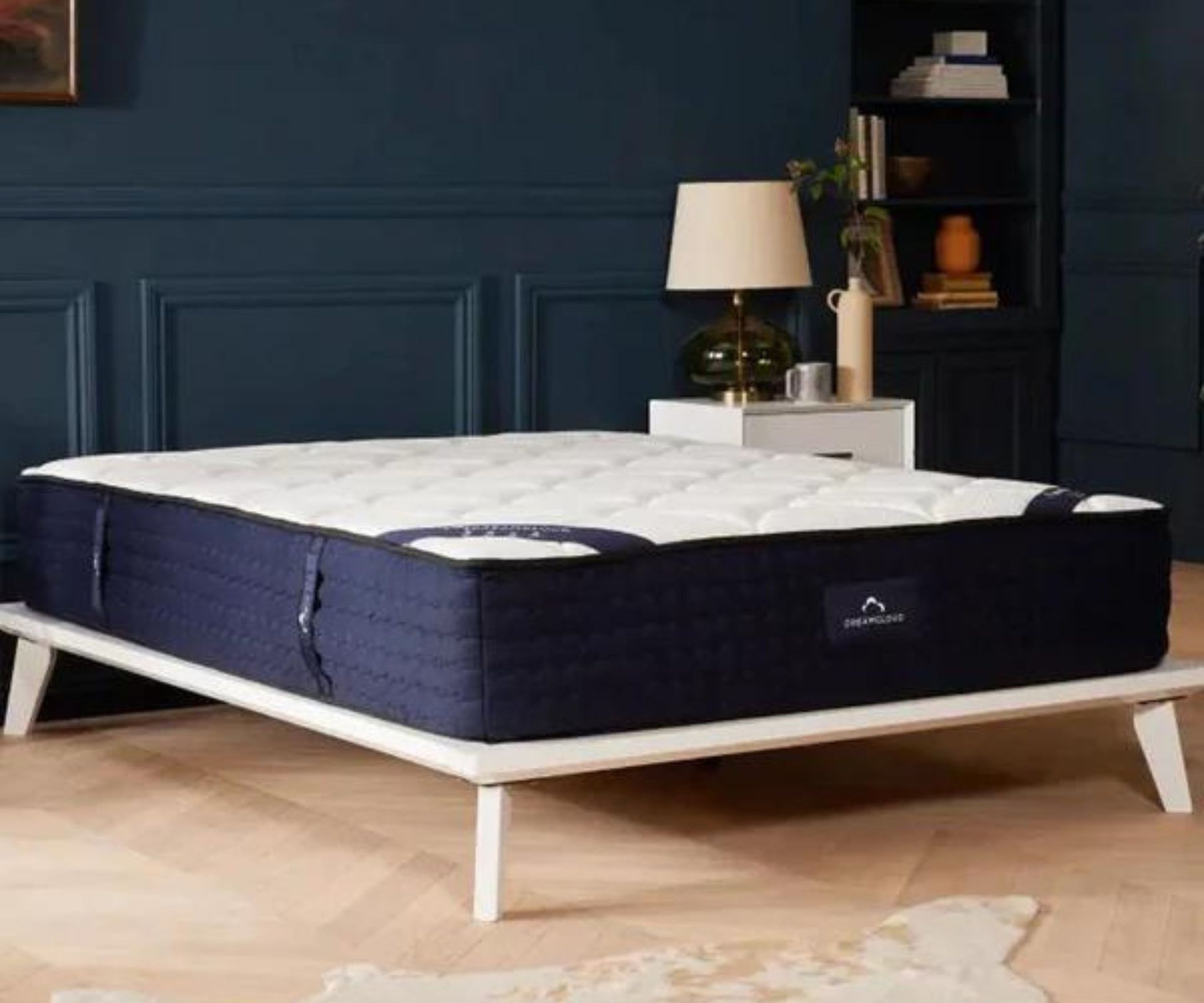 DreamCloud Luxury Hybrid Mattress on a bed shot from the side.