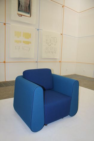 An armchair covered in bright blue fabric