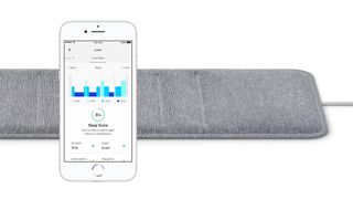 Close up of Withings Sleep Analyzer Mat with app shown on phone