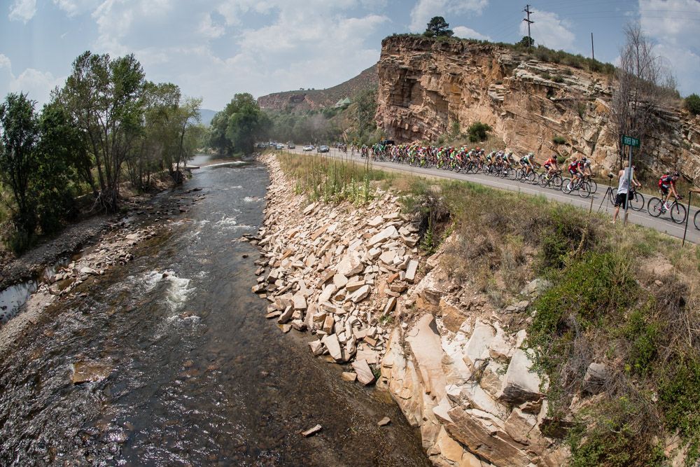 The peloton passes along a rider on todays route