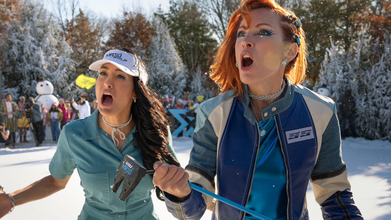 Nikki Garcia and Becky Lynch stand looking furious on the golf course in Happy Gilmore 2.