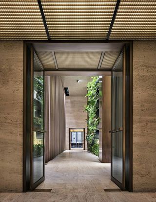 Hallway with glass door and green plants