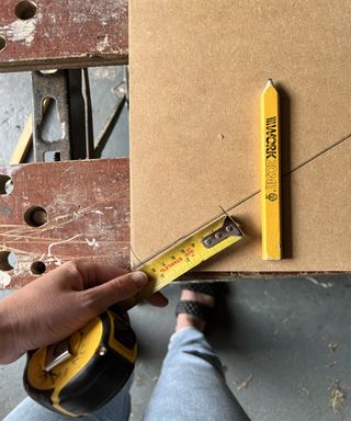 Hand measuring table with a tape measure and a pencil