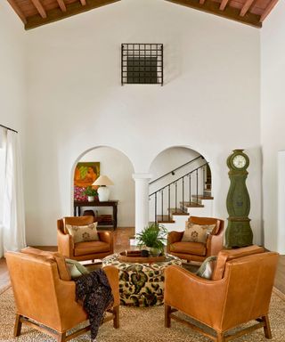 living room with arched entrance club chairs and mora clock