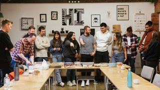 group of people standing around a table