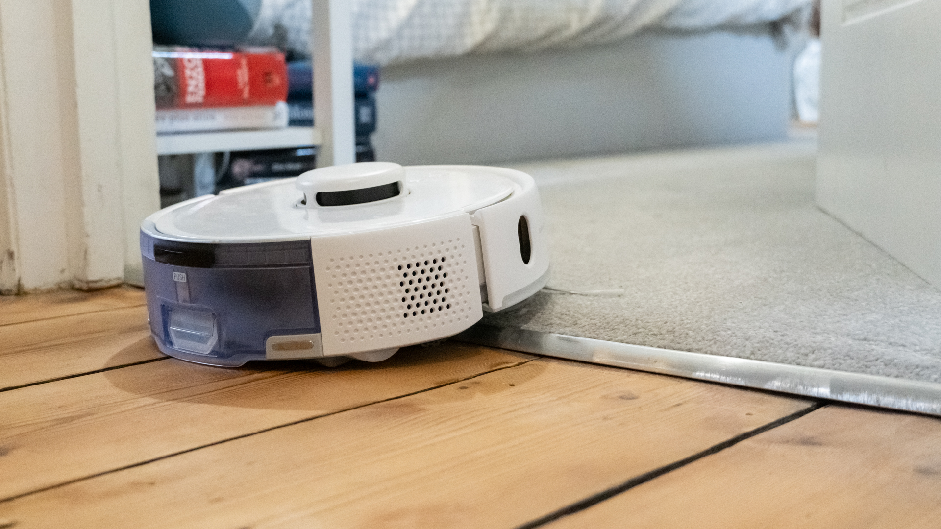 SwitchBot K10+ Pro mini robot vacuum struggling to get over a room threshold