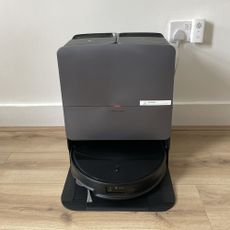 Roborock Saros 20 Robot Vacuum on its dock, sitting on wood effect flooring