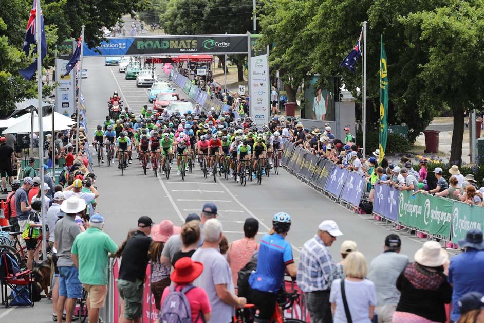 The peloton crosses the line for lap two