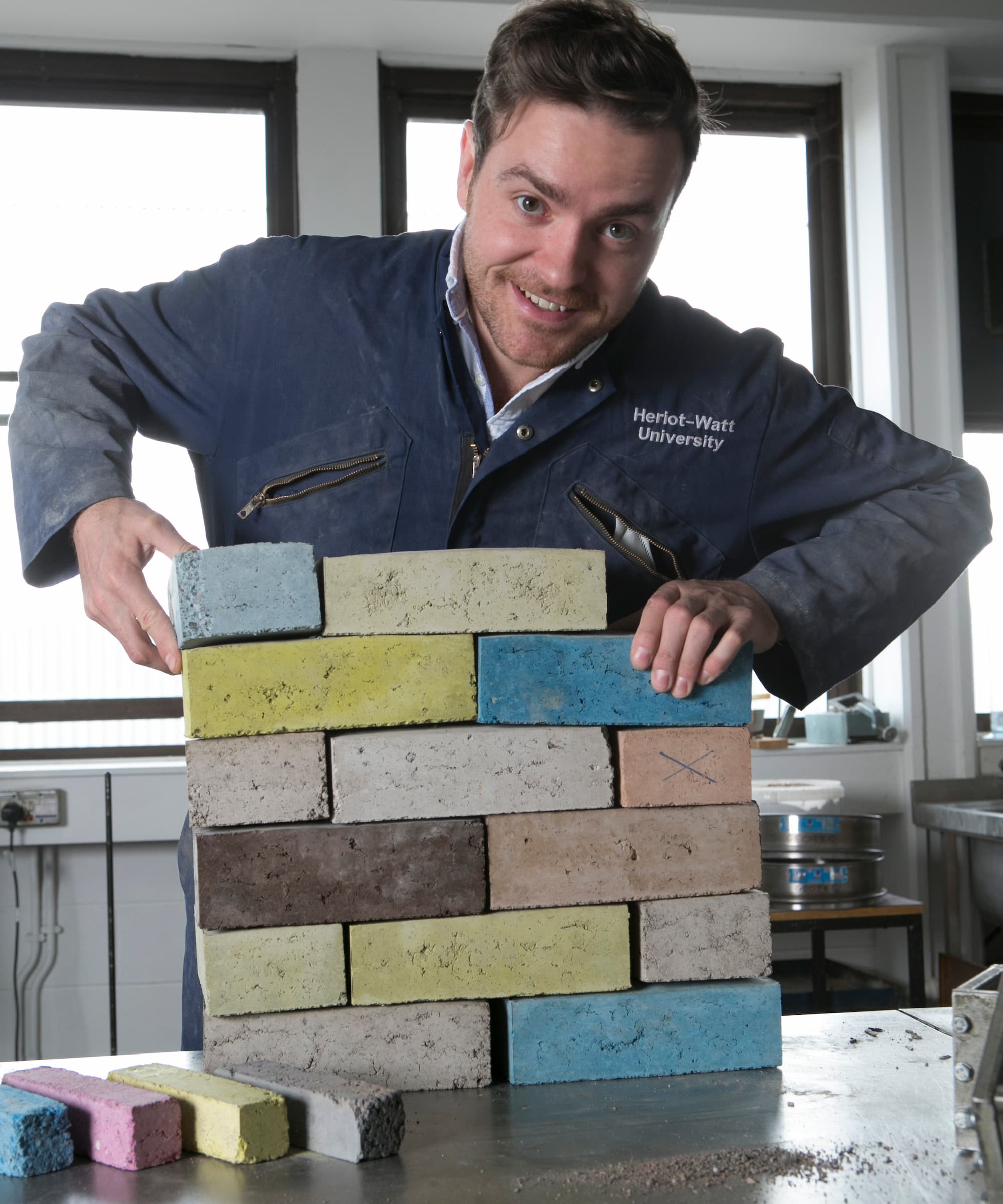 Dr Sam Chapman, co-founder of Kenoteq, with different coloured bricks