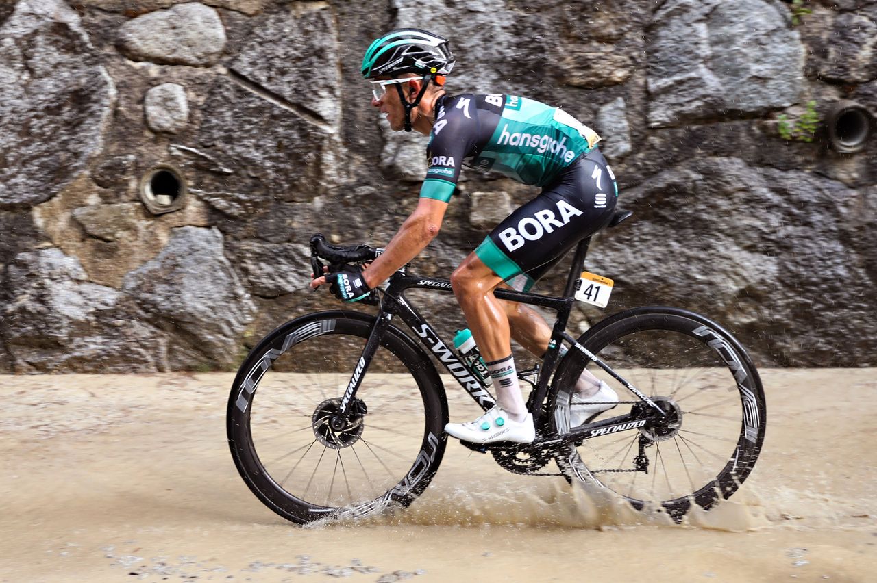 Rafal Majka rides through the waterlogged gravel section
