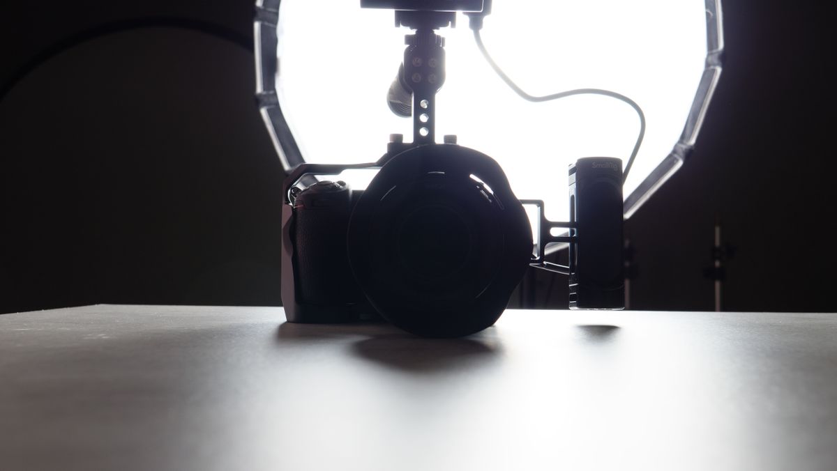 A backlit photo of a Nikon Z7 II camera with a studio light behind it.