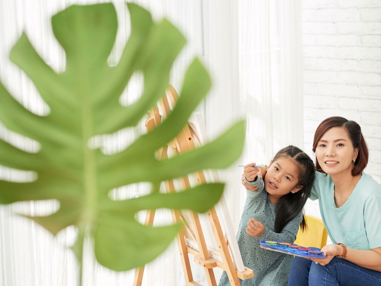 Lady And Child Looking At A Green Leaf And Painting