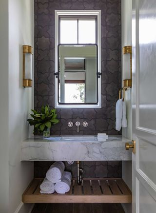 a small bathroom with a mirror over the window