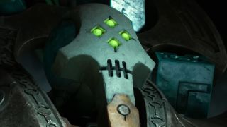 A four-eyed necron bathed in light